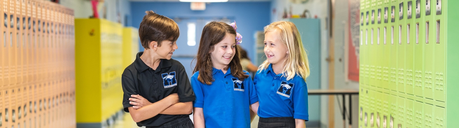 Laughing Lower School students in hallway