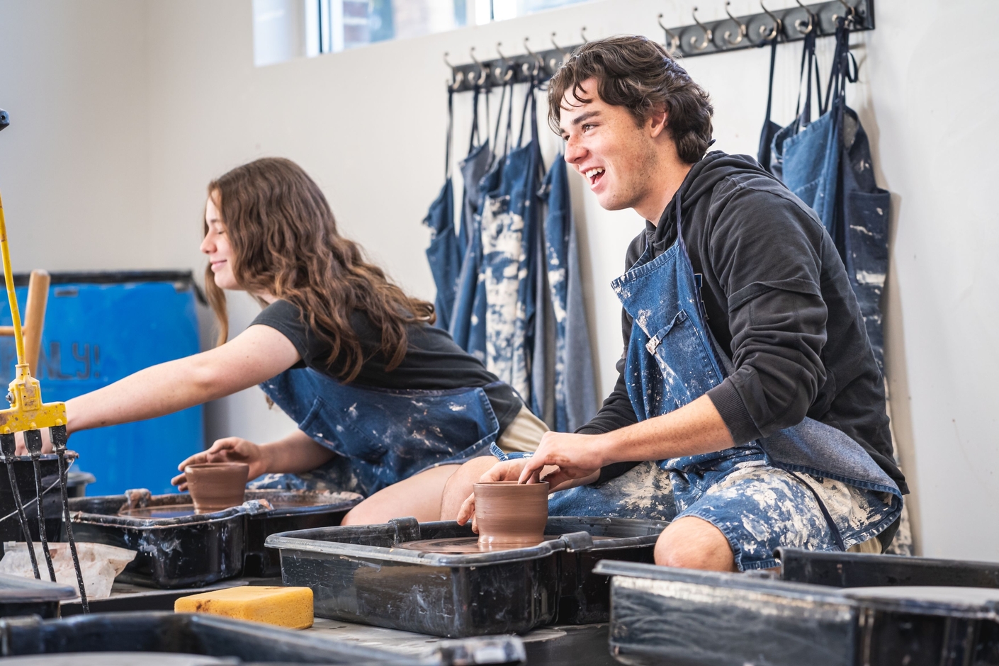 High School Art students on pottery wheel